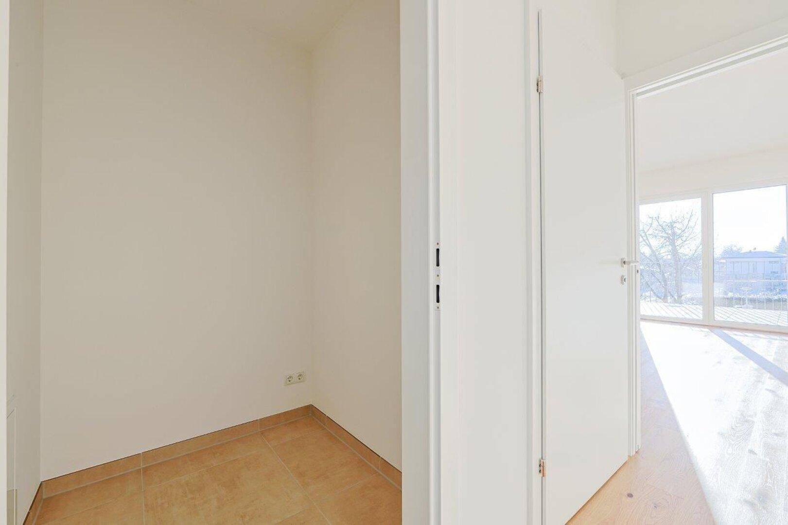 Kleiner Abstellraum mit Fliesenboden und Steckdosen, ideal für zusätzlichen Stauraum.