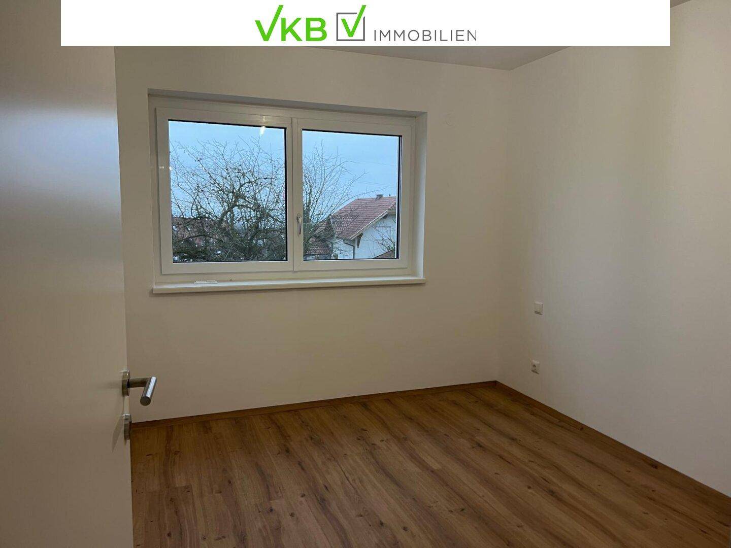 Helles Zimmer mit Holzboden und einem Fenster, ideal als Schlaf- oder Arbeitszimmer.