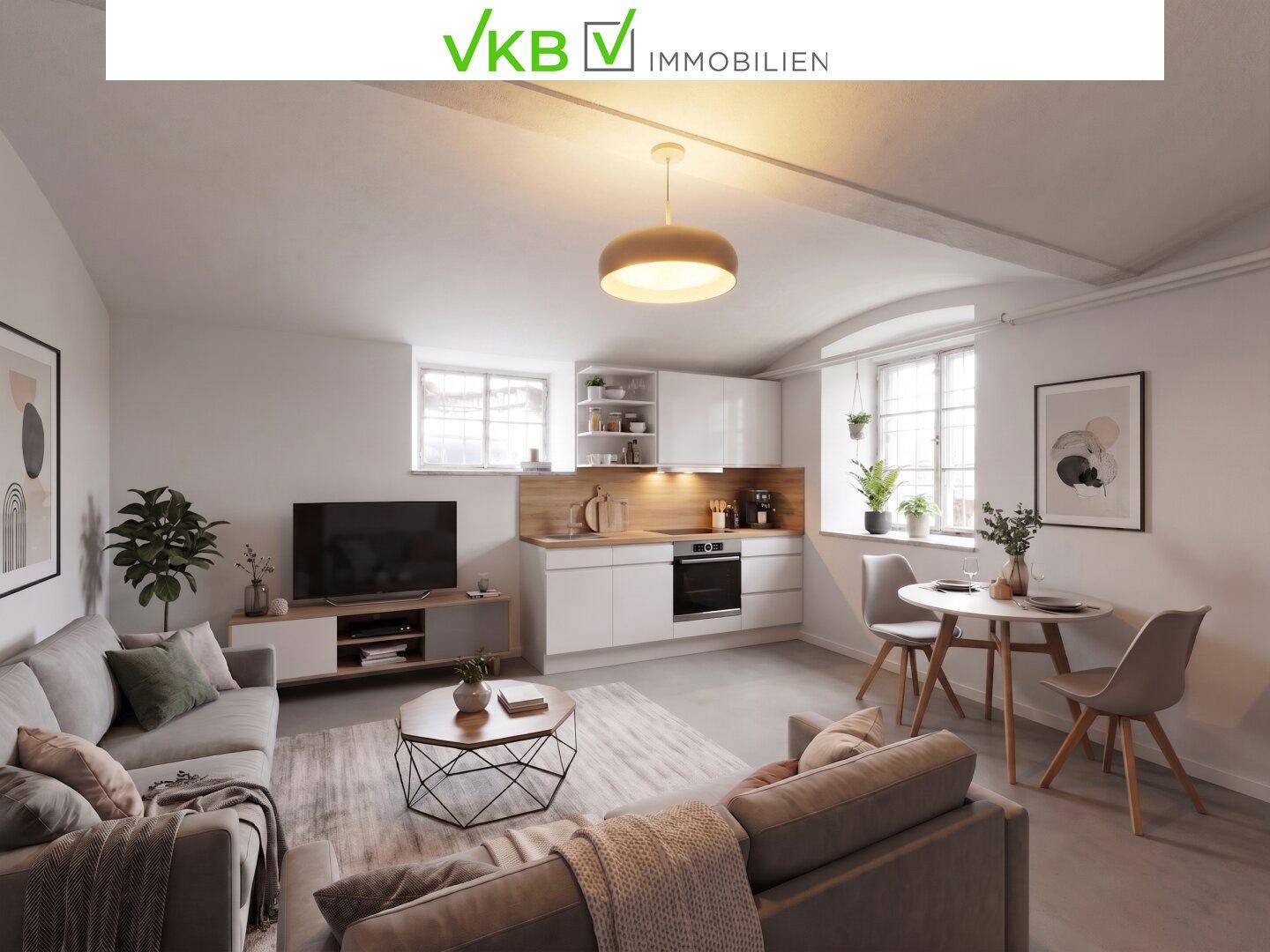 Gemütlicher Wohnbereich mit integrierter Küchenzeile, Sofa und Esstisch.
