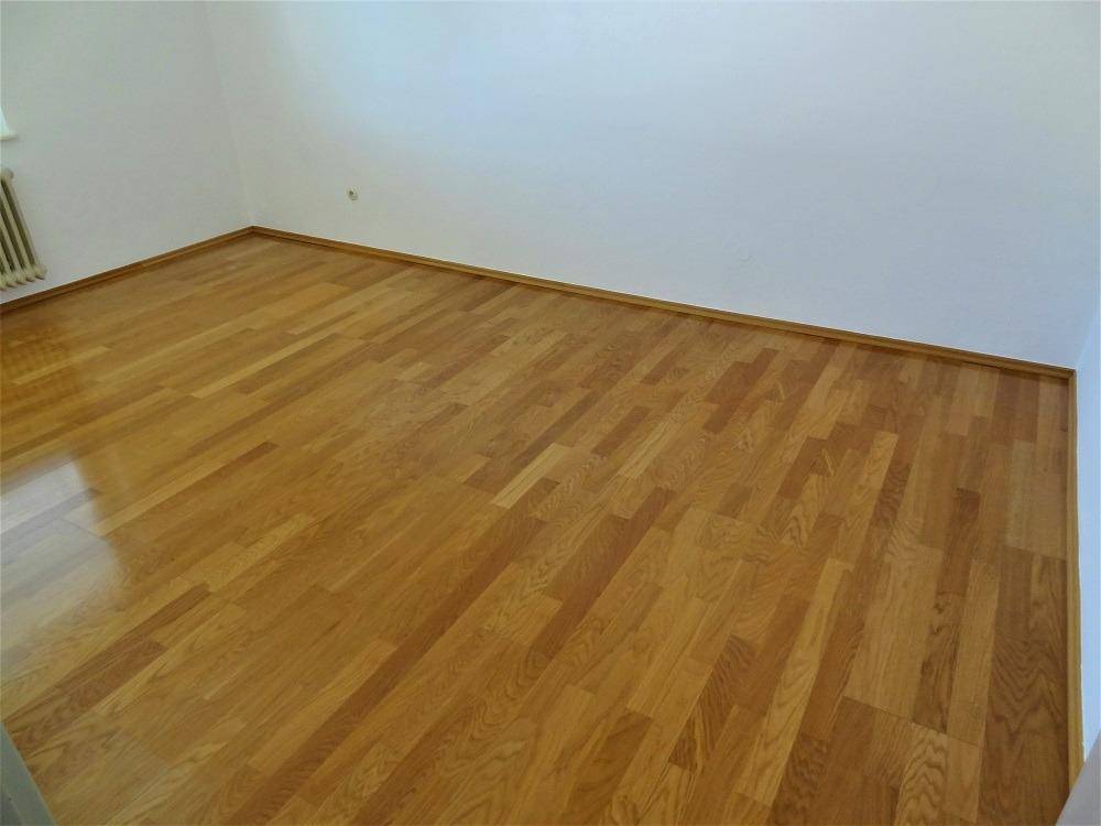 Detailansicht des gepflegten Parkettbodens in einem hellen Wohnraum.