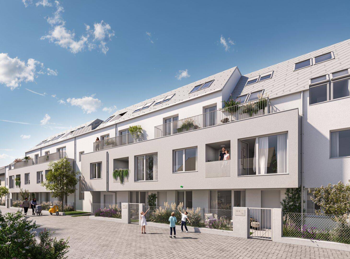 Moderne Wohnanlage mit weißer Fassade, Balkonen und Dachfenstern unter blauem Himmel.