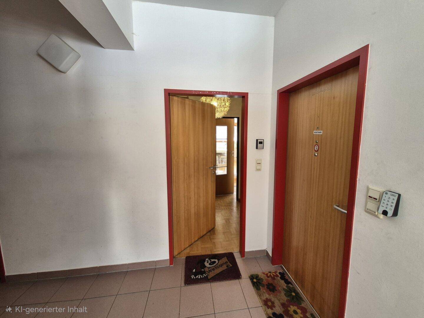 Eingangsbereich mit Holztüren und Fliesenboden, der zu verschiedenen Räumen führt.