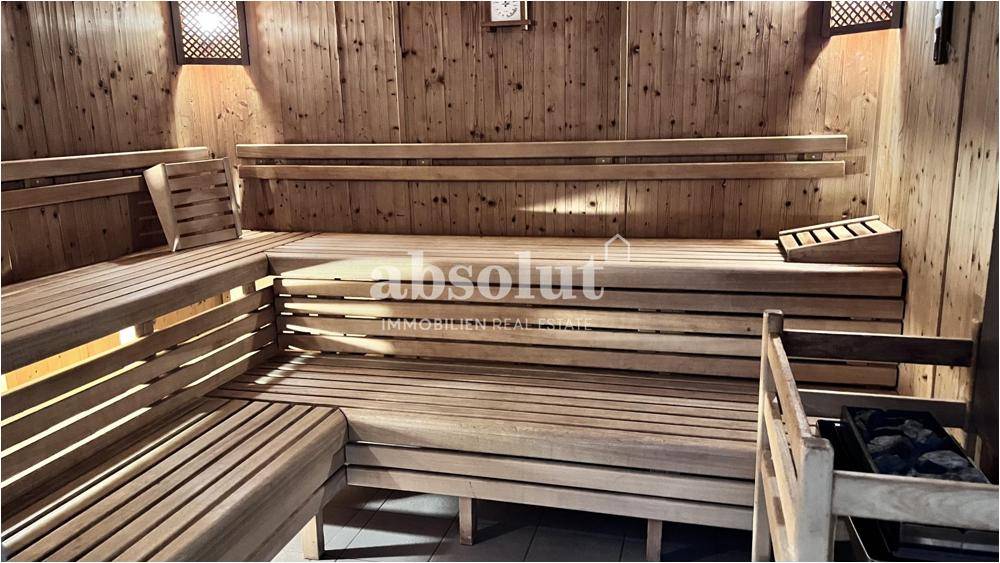 Geräumige Holzsauna mit mehreren Bänken für Entspannung und Wellness.