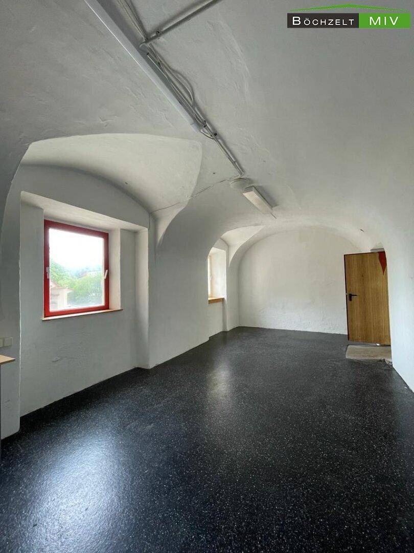 Historischer Kellerraum mit Gewölbedecken und dunklem Terrazzoboden, bietet kühle Lagerflächen.