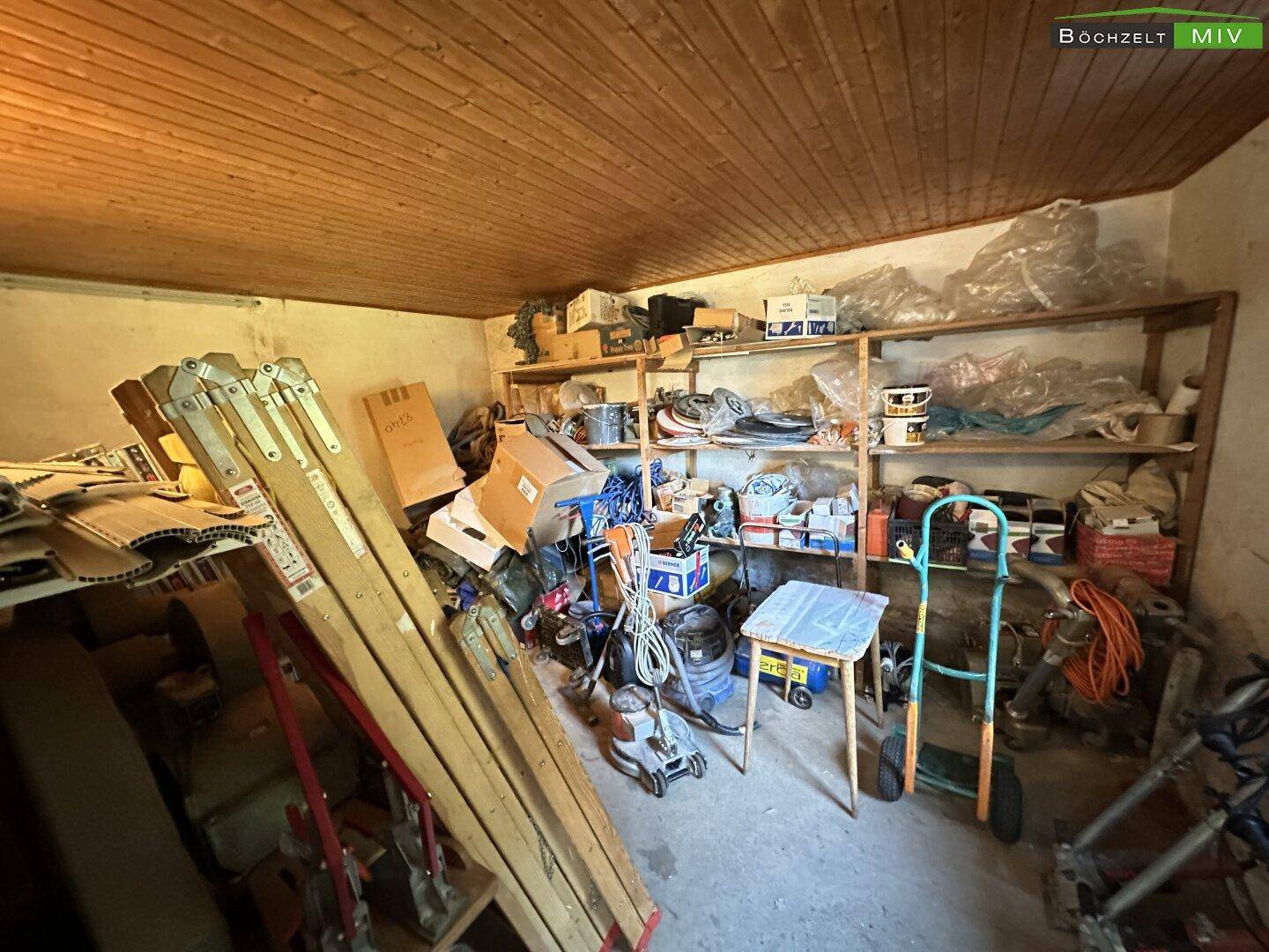 Lagerraum mit Holzdecke, Regalen voller Gegenstände und Werkzeugen.