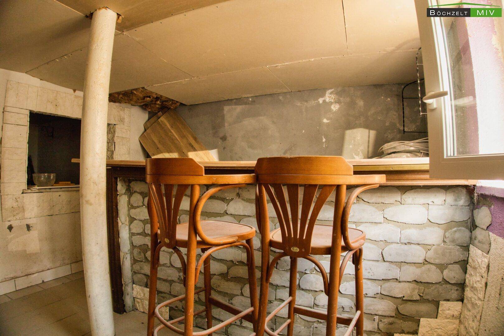 Kellerbar mit gemauerter Theke und Holzstühlen, ideal für gesellige Abende.