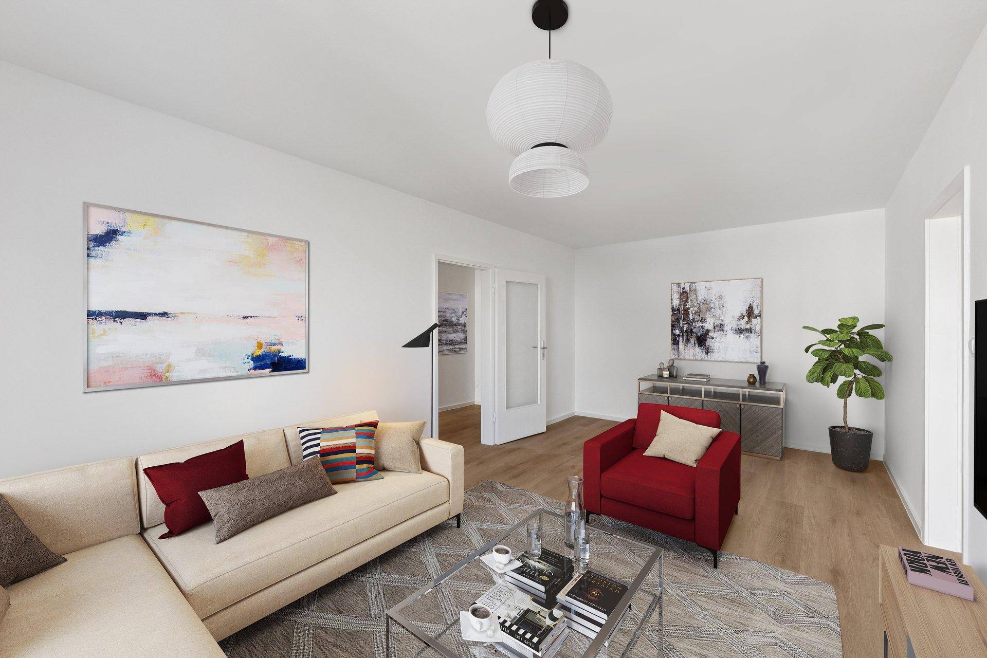 Geräumiges Wohnzimmer mit hellem Sofa, rotem Sessel und modernem Dekor.