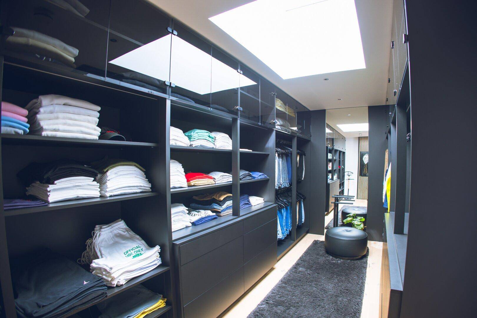 Geräumiger begehbarer Kleiderschrank mit viel Stauraum und Oberlicht.
