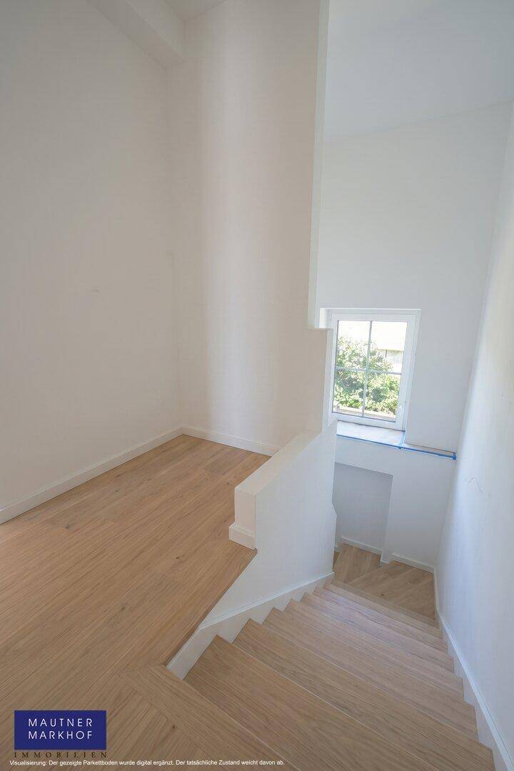 Heller Treppenbereich mit Holztreppe und einem Fenster, das den Flur mit Tageslicht versorgt.