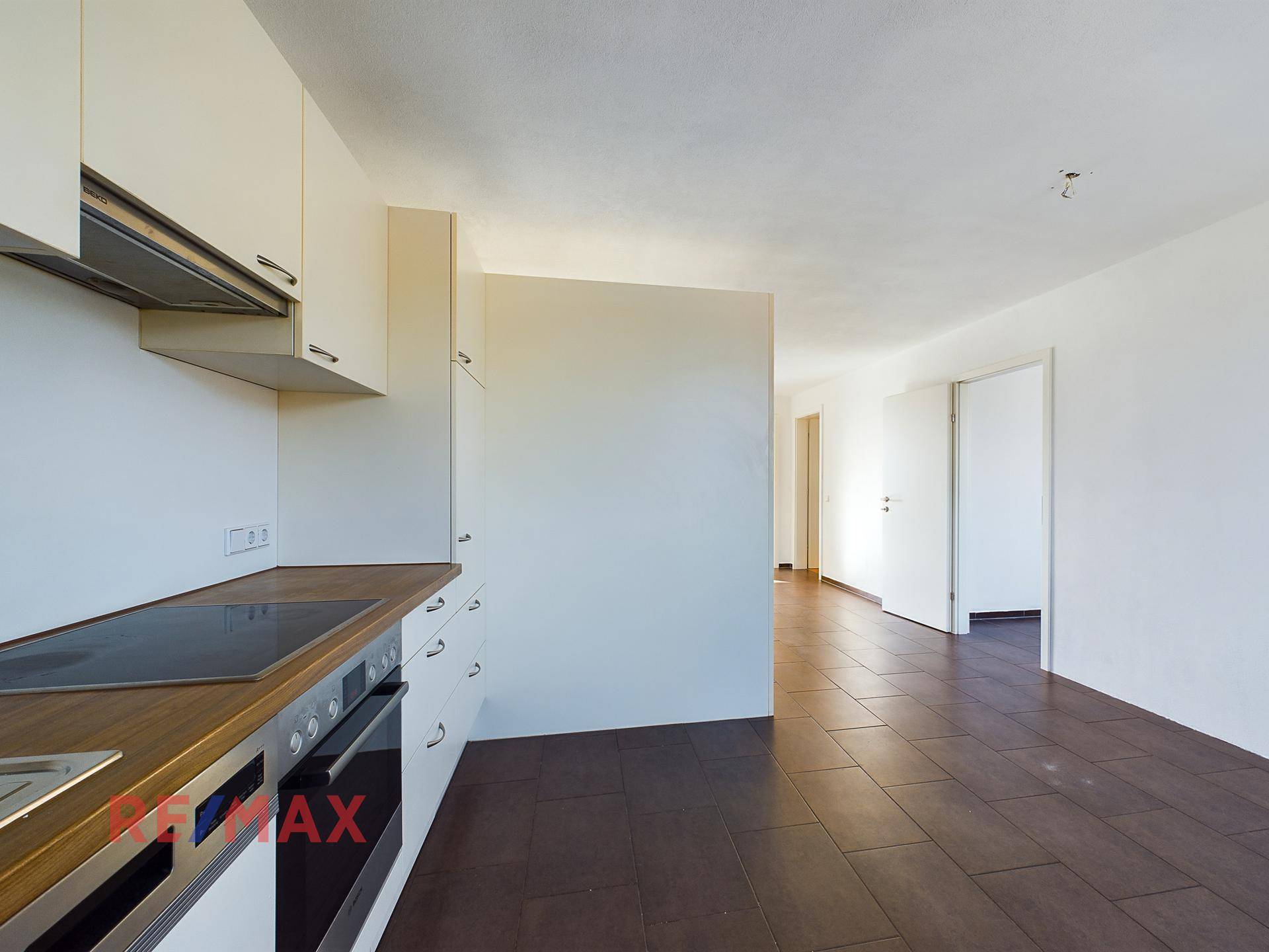 Einbauküche mit Cerankochfeld, Backofen und Holz-Arbeitsplatte.