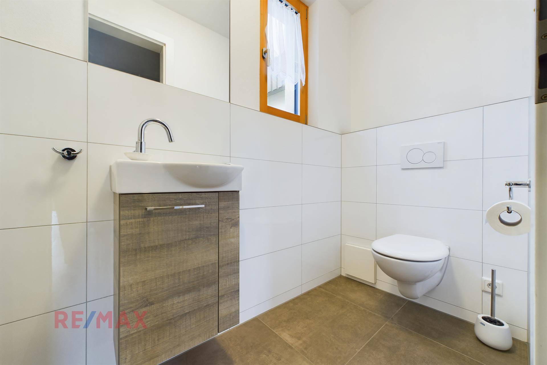 Modernes Gäste-WC mit wandhängender Toilette, kleinem Waschbecken und Fenster.