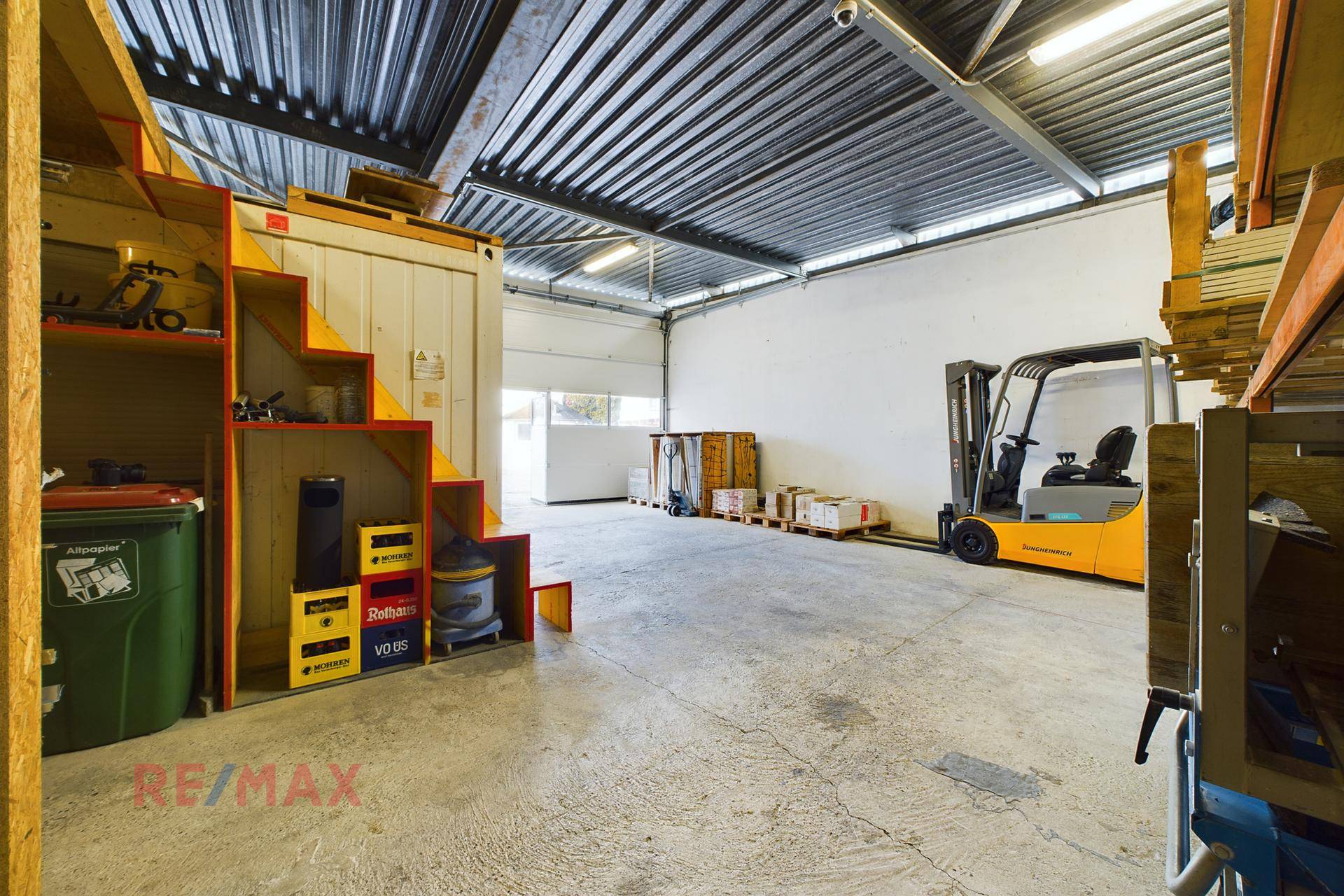 Innenansicht einer Lagerhalle mit Gabelstapler und Regalsystemen.