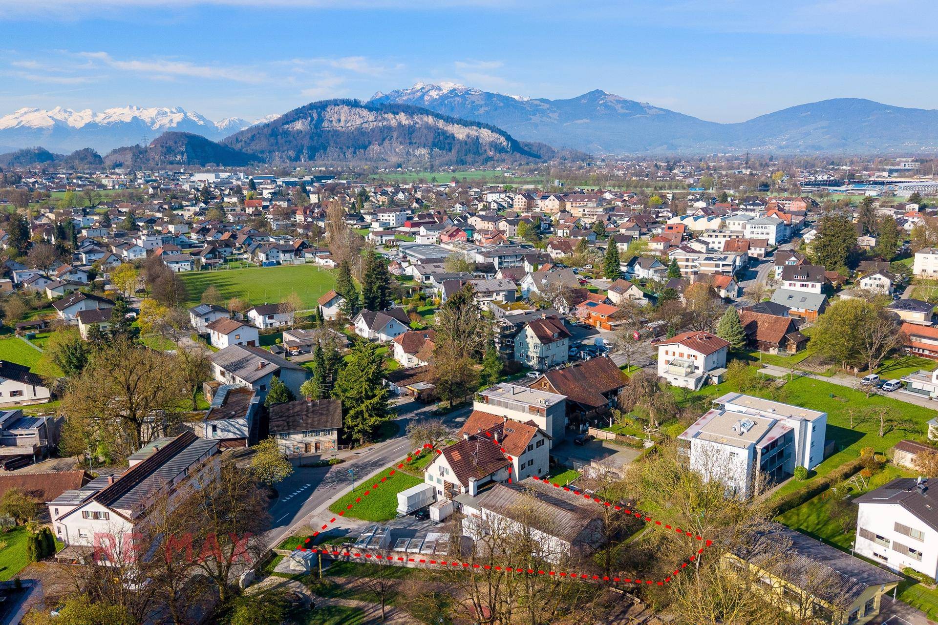 Weitwinkel-Luftaufnahme des Anwesens in einer Siedlung mit beeindruckendem Bergblick.