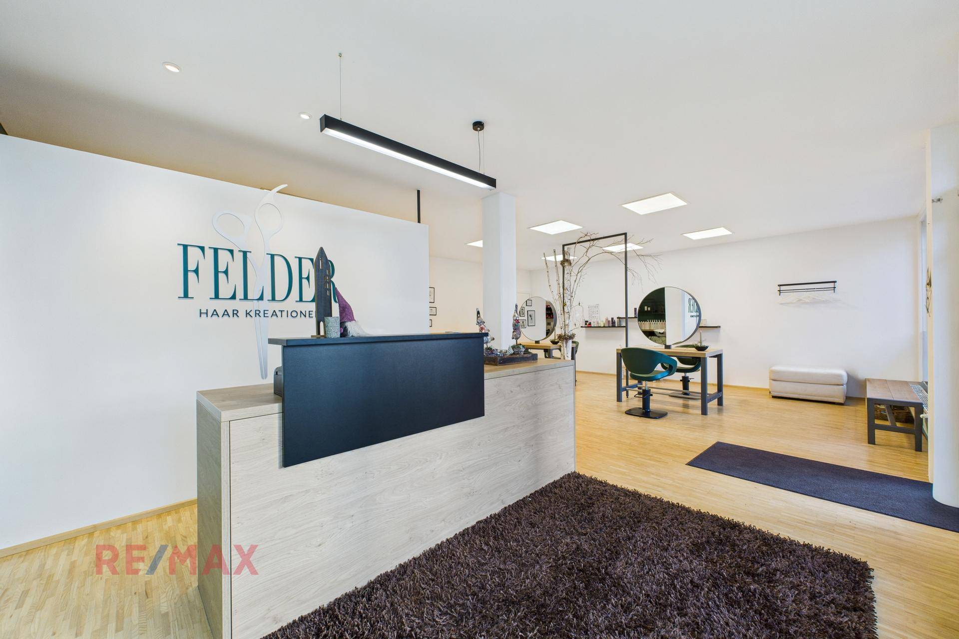 Weitläufiger Empfangs- und Salonbereich mit modernem Design und hellen Oberflächen.