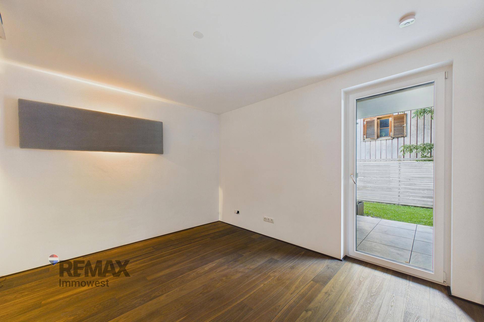Heller Raum mit Holzboden und direktem Zugang zur Terrasse oder zum Gartenbereich.