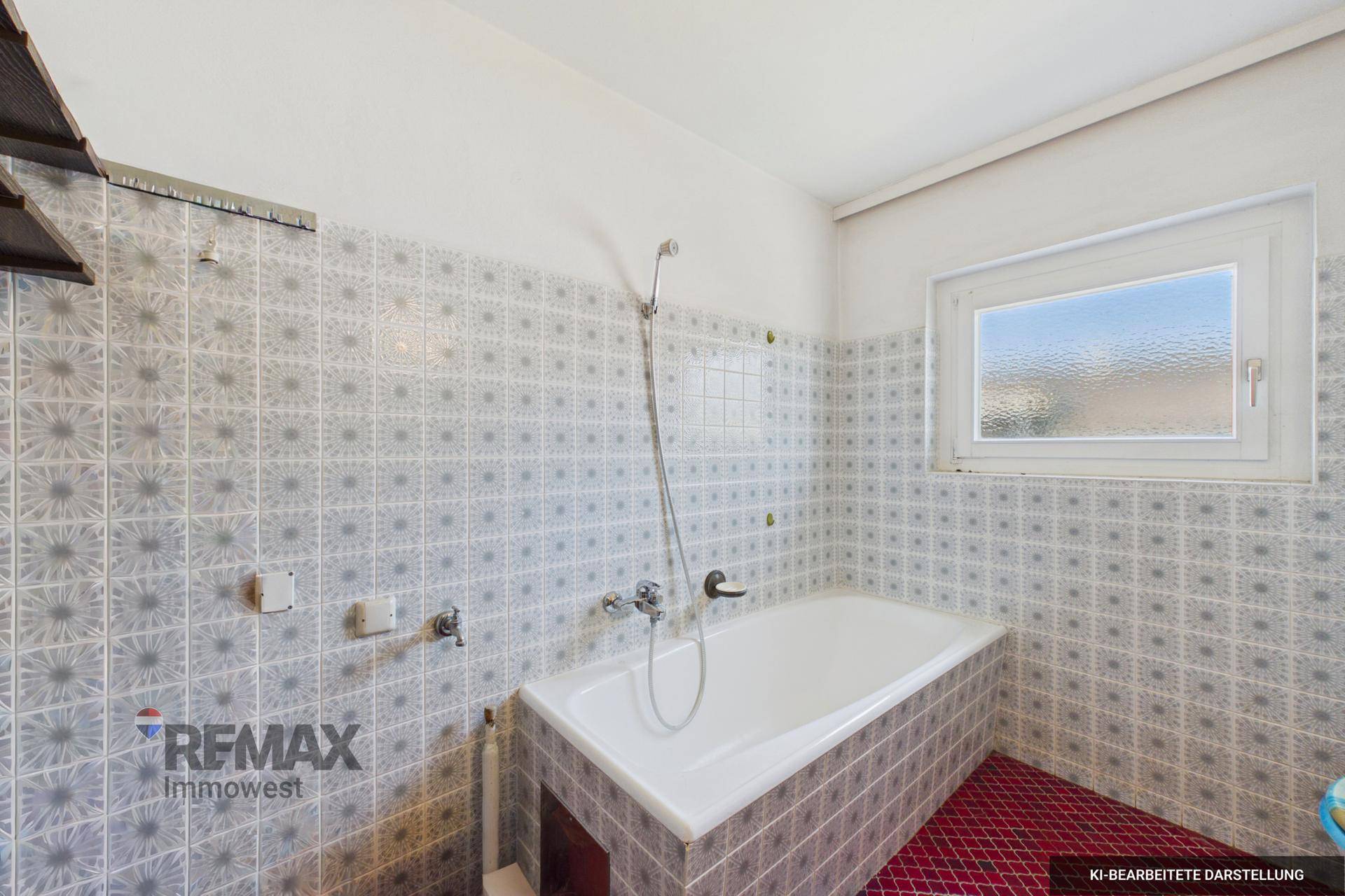 Badezimmer mit gemusterten Fliesen, Badewanne und Fenster, mit auffälligem roten Boden.