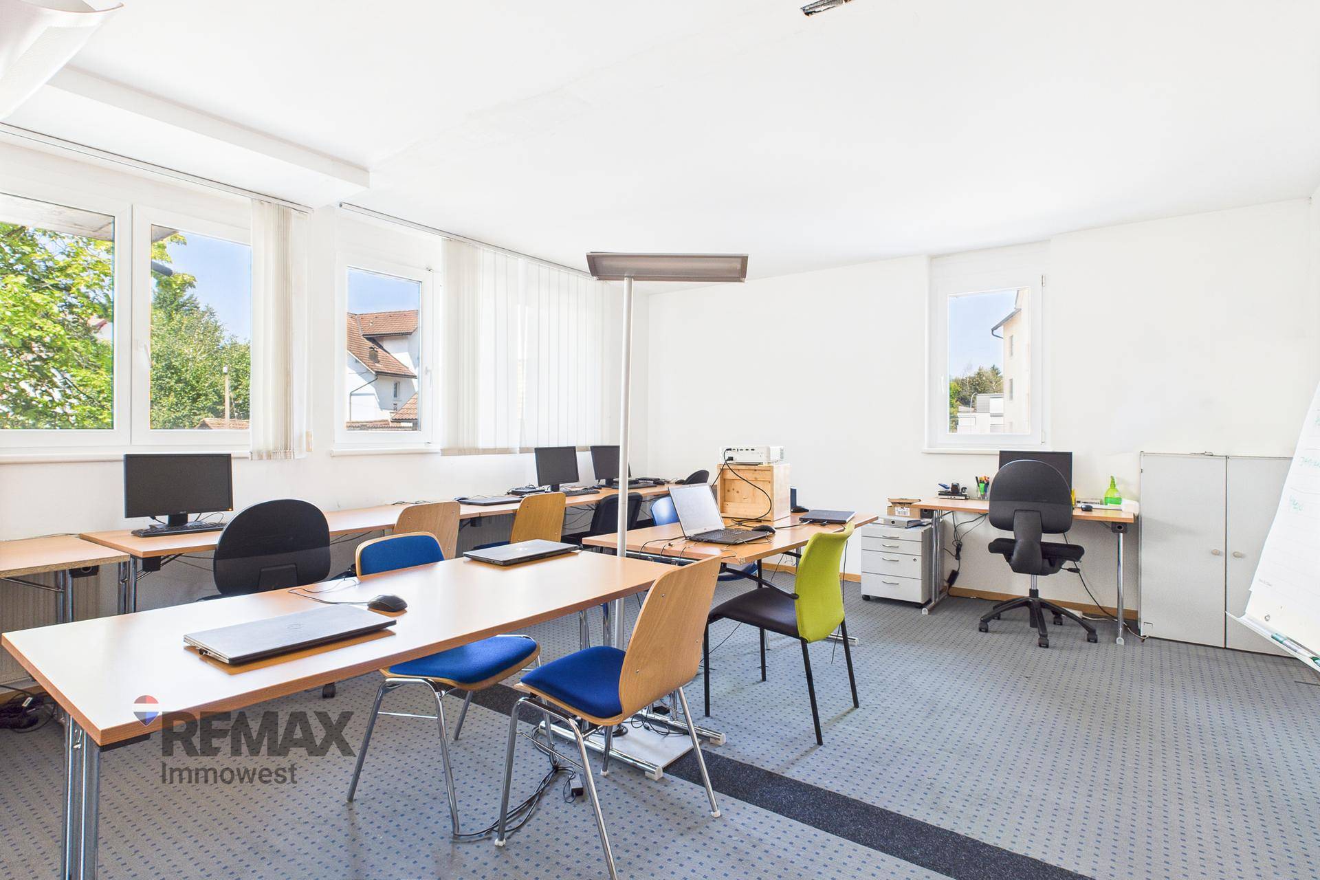 Schulungsraum mit Computern, Tischen und Stühlen, ideal für IT-Kurse und digitale Arbeit.