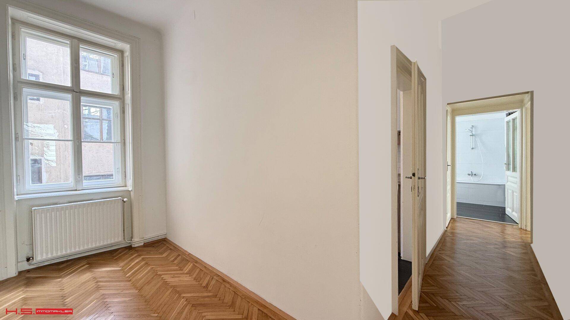 Langer Flur mit Fischgrätparkett, der zu einem Badezimmer mit Badewanne führt.