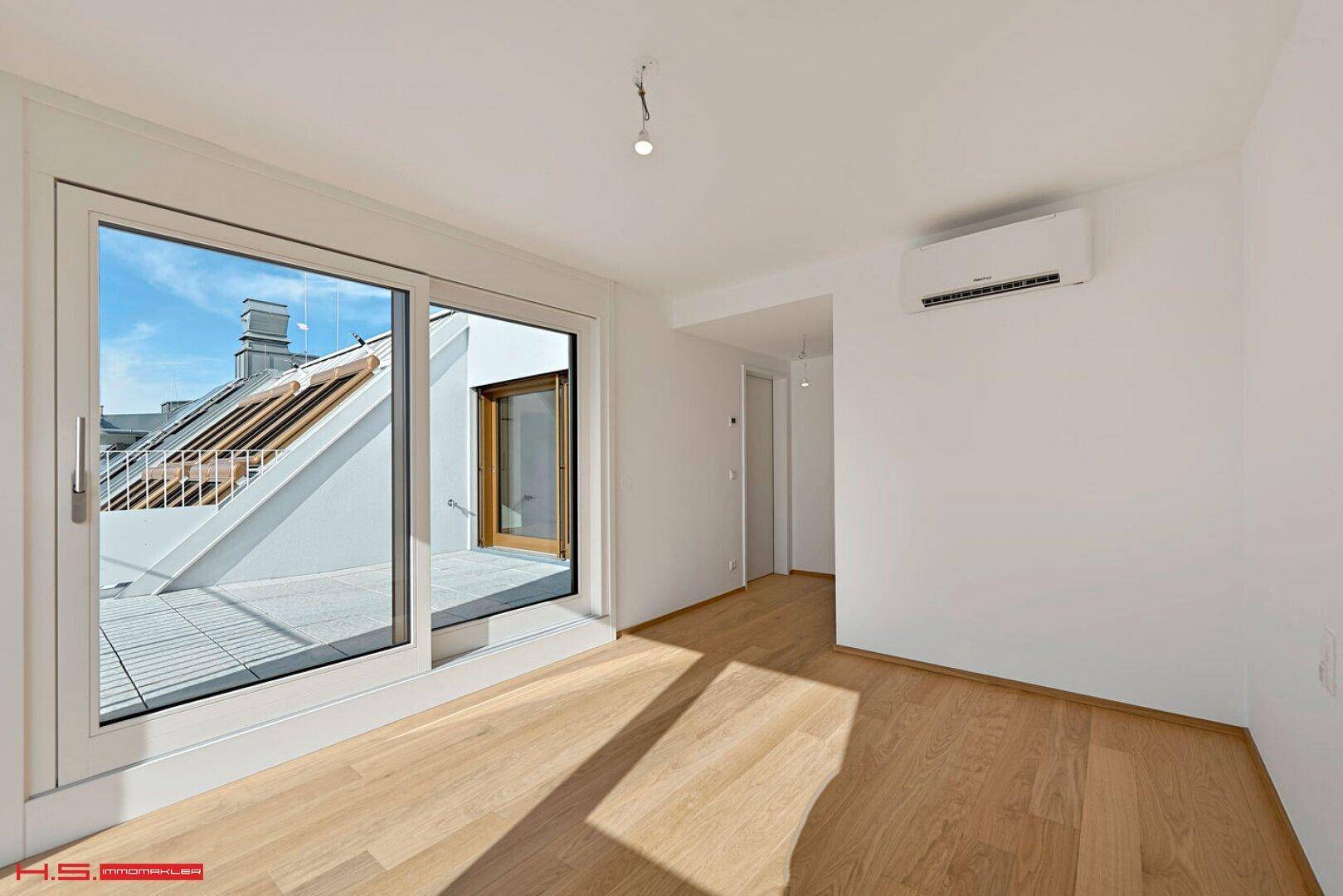 Helles Schlafzimmer mit Zugang zur Terrasse und Klimaanlage, ideal für erholsame Nächte.