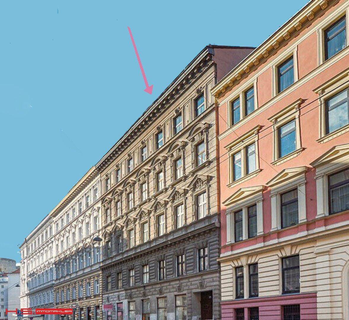 Historisches Mehrfamilienhaus mit klassischer Fassade und vielen Fenstern in urbaner Umgebung.