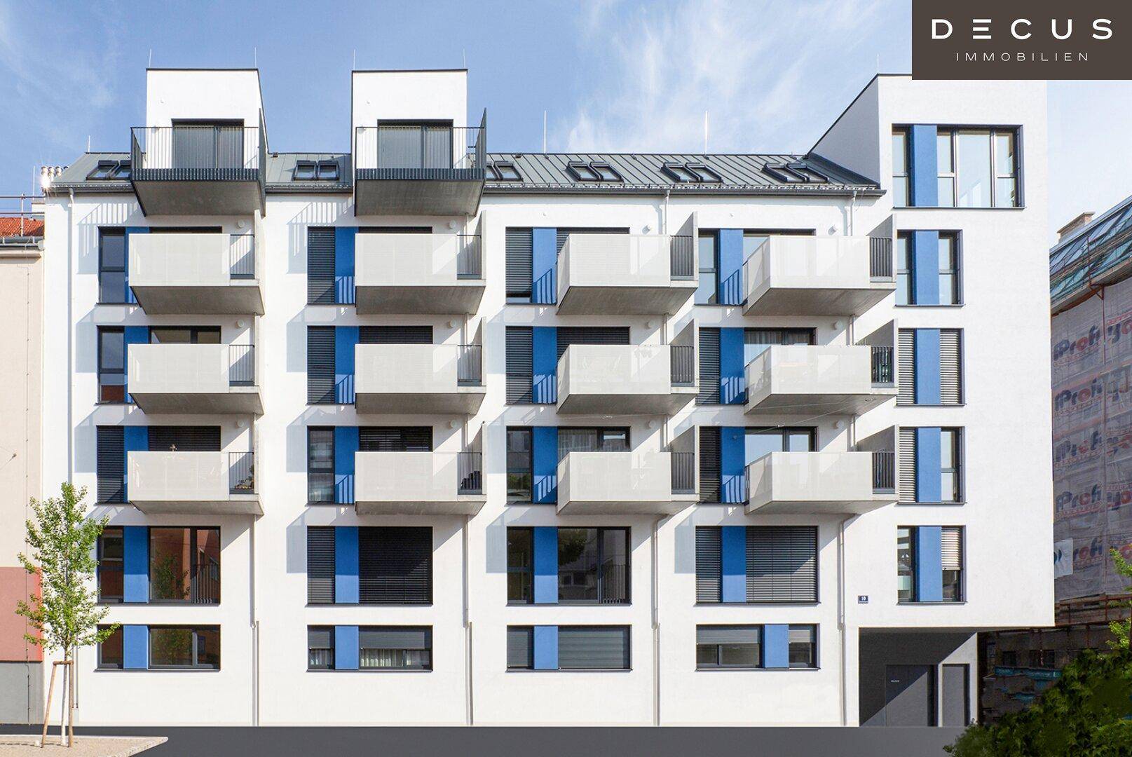 Ansicht der modernen Wohnhausfassade mit vielen Balkonen und blauen Fensterläden.