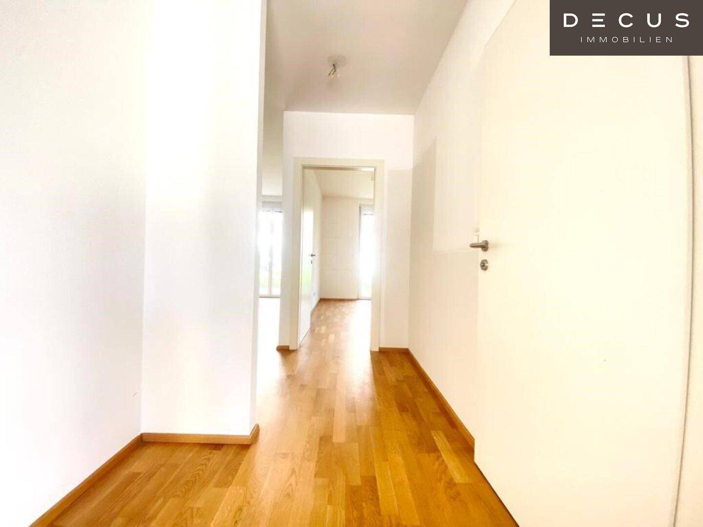 Heller Flur mit Parkettboden, der zu den weiteren Räumen der Wohnung führt.