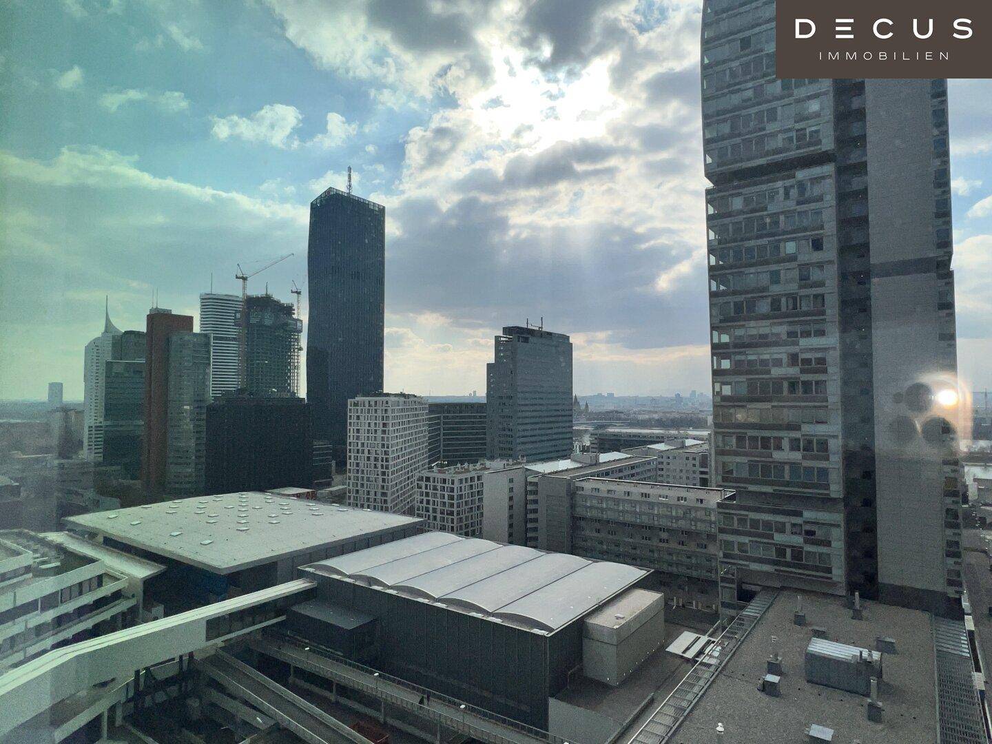 Beeindruckender Blick auf moderne Wolkenkratzer und die städtische Skyline unter einem bewölkten Himmel.