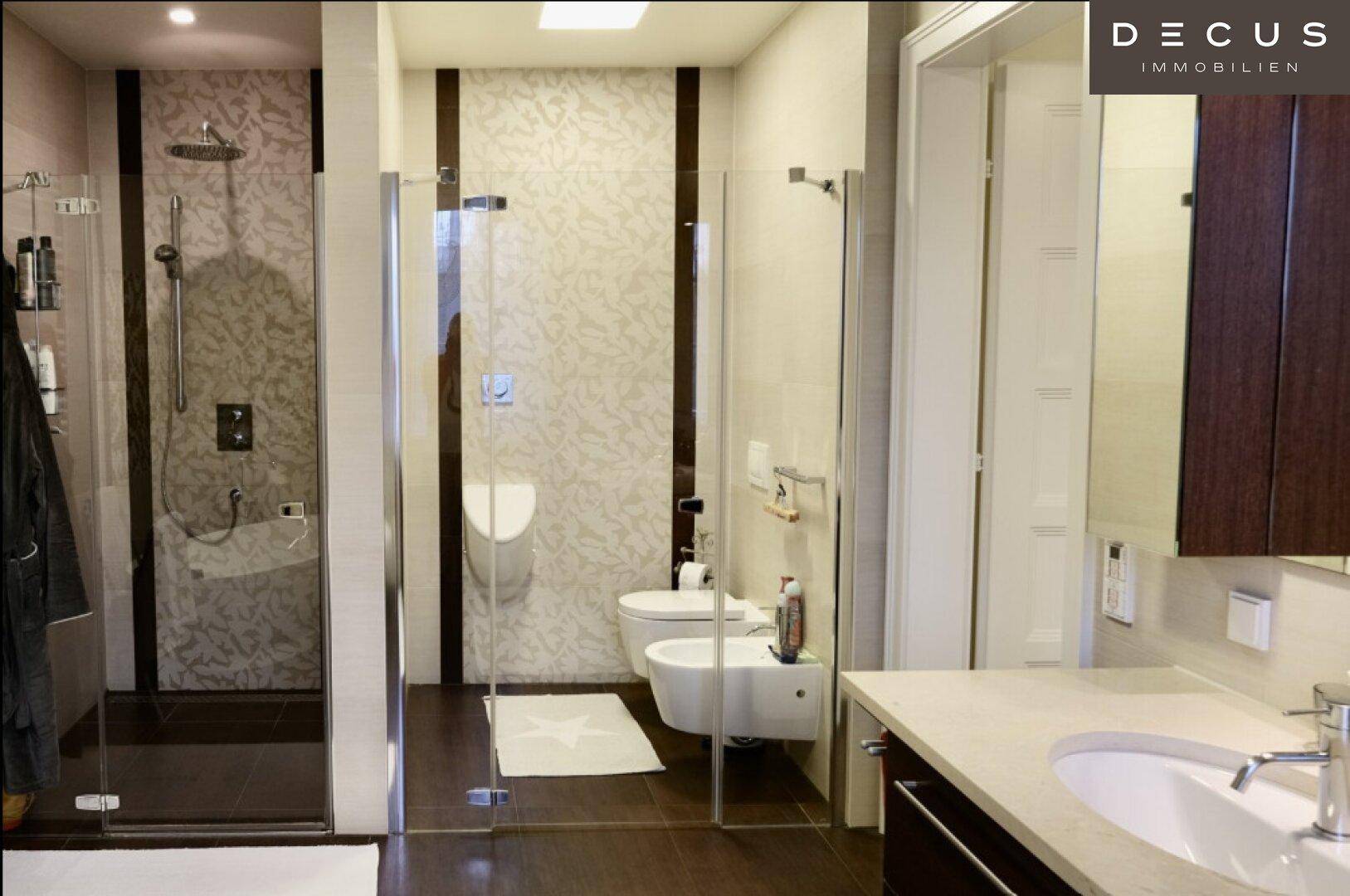 Elegantes Badezimmer mit begehbarer Dusche, Wand-WC und Bidet, akzentuiert durch dekorative Fliesen.