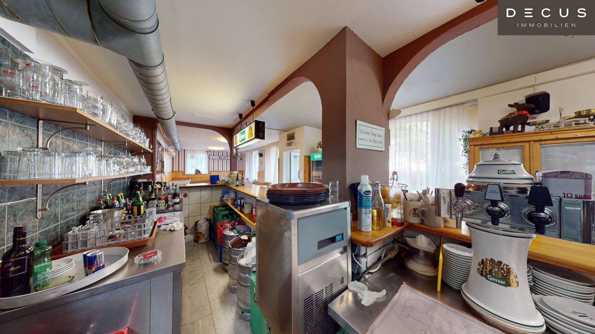 Thekenbereich mit Zapfanlage, Kaffeemaschine und vielen Gläsern, bereit für den Service.