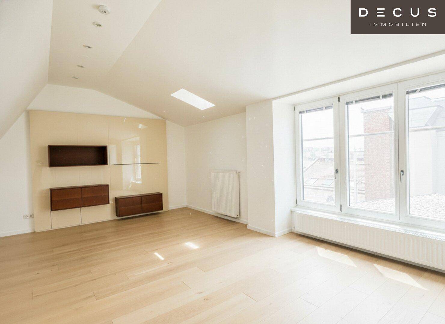 Helles Schlafzimmer mit Holzboden, Einbauregalen und einem großen Fenster mit Blick nach draußen.
