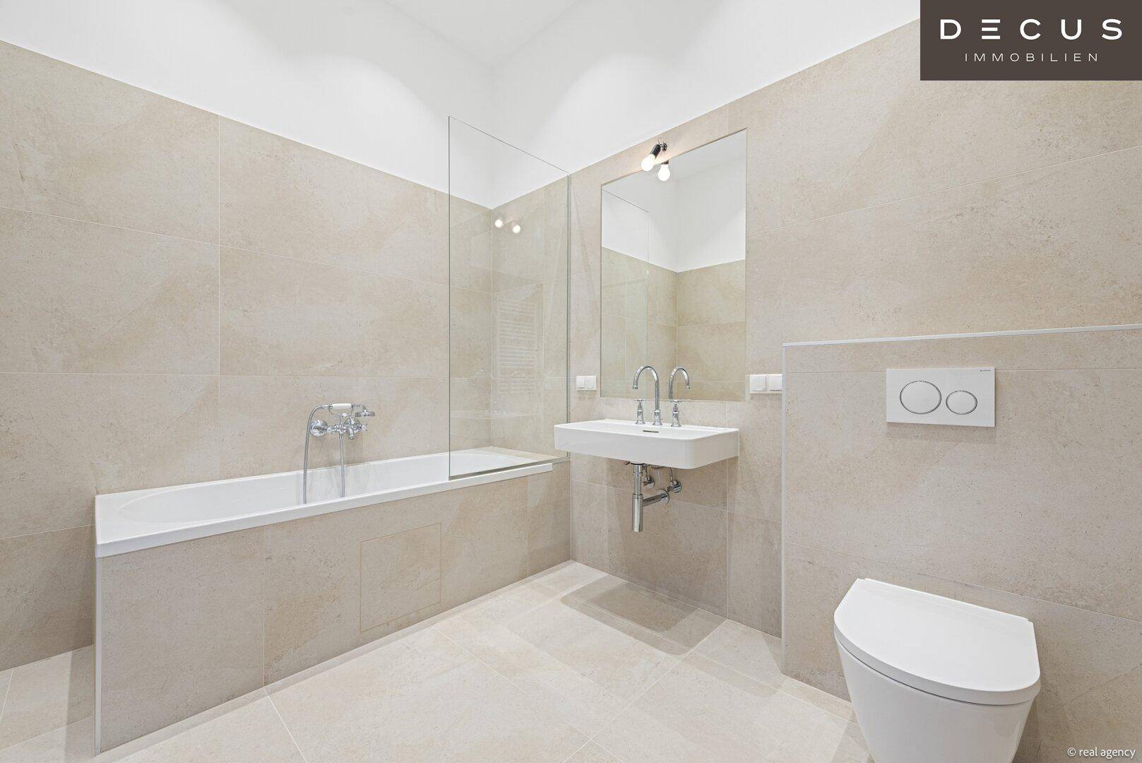 Helles Badezimmer mit modernen Fliesen, Badewanne und elegantem Waschbecken.