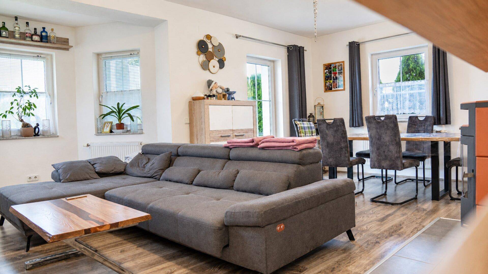 Offener Wohn- und Essbereich mit großem Ecksofa und Esstisch, hell und modern eingerichtet.