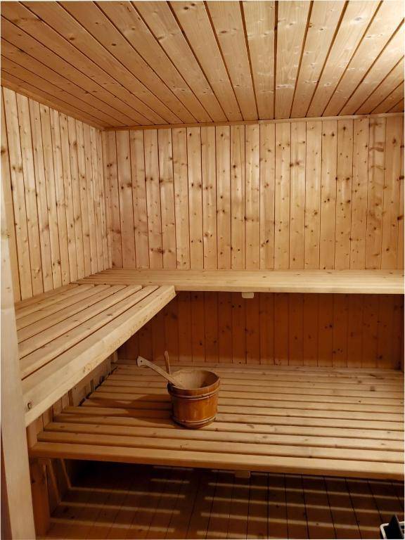 Geräumige Holzsauna mit mehreren Ebenen von Bänken für entspannende Wellnessmomente.