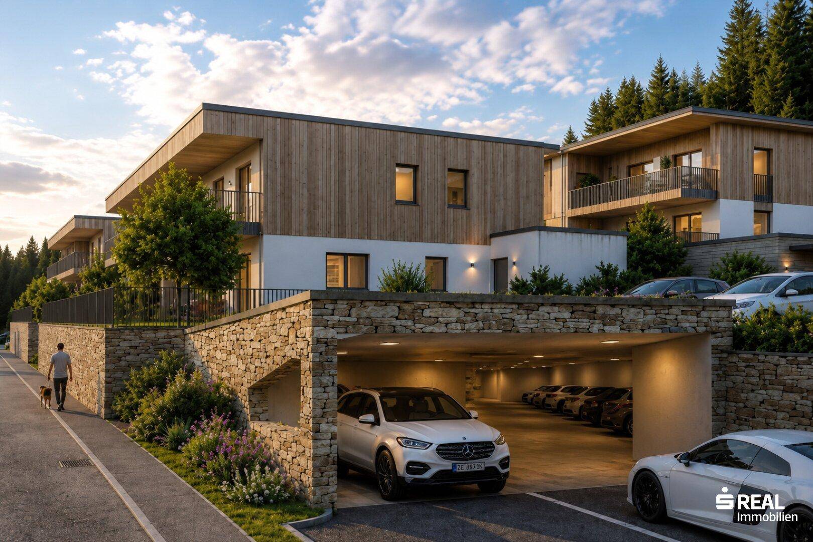 Moderne Wohnanlage mit Tiefgaragenzufahrt und attraktiver Steinfassade.