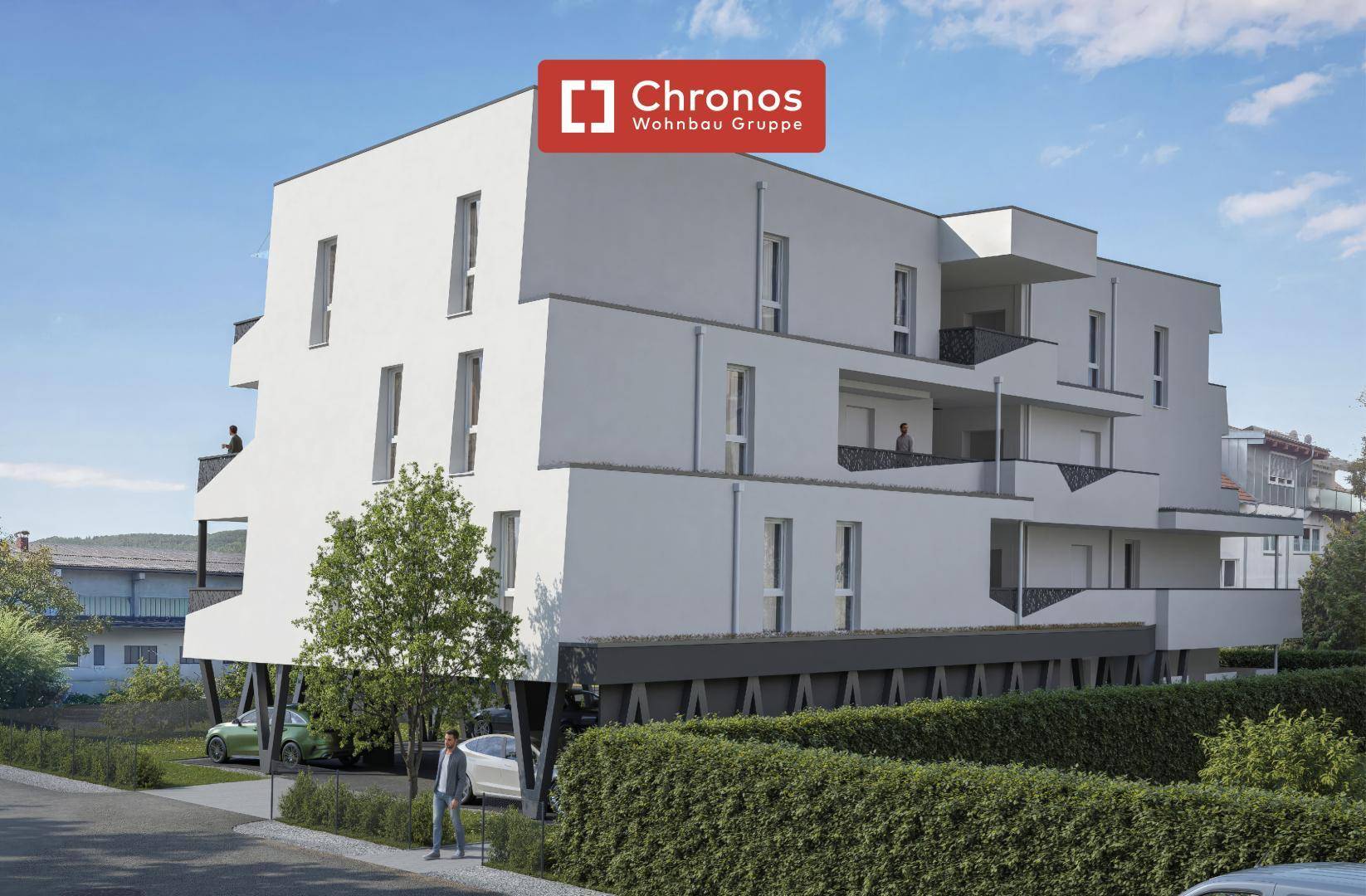 Zeitgenössisches Wohngebäude mit weißer Fassade, großen Fenstern und integrierten Balkonen.