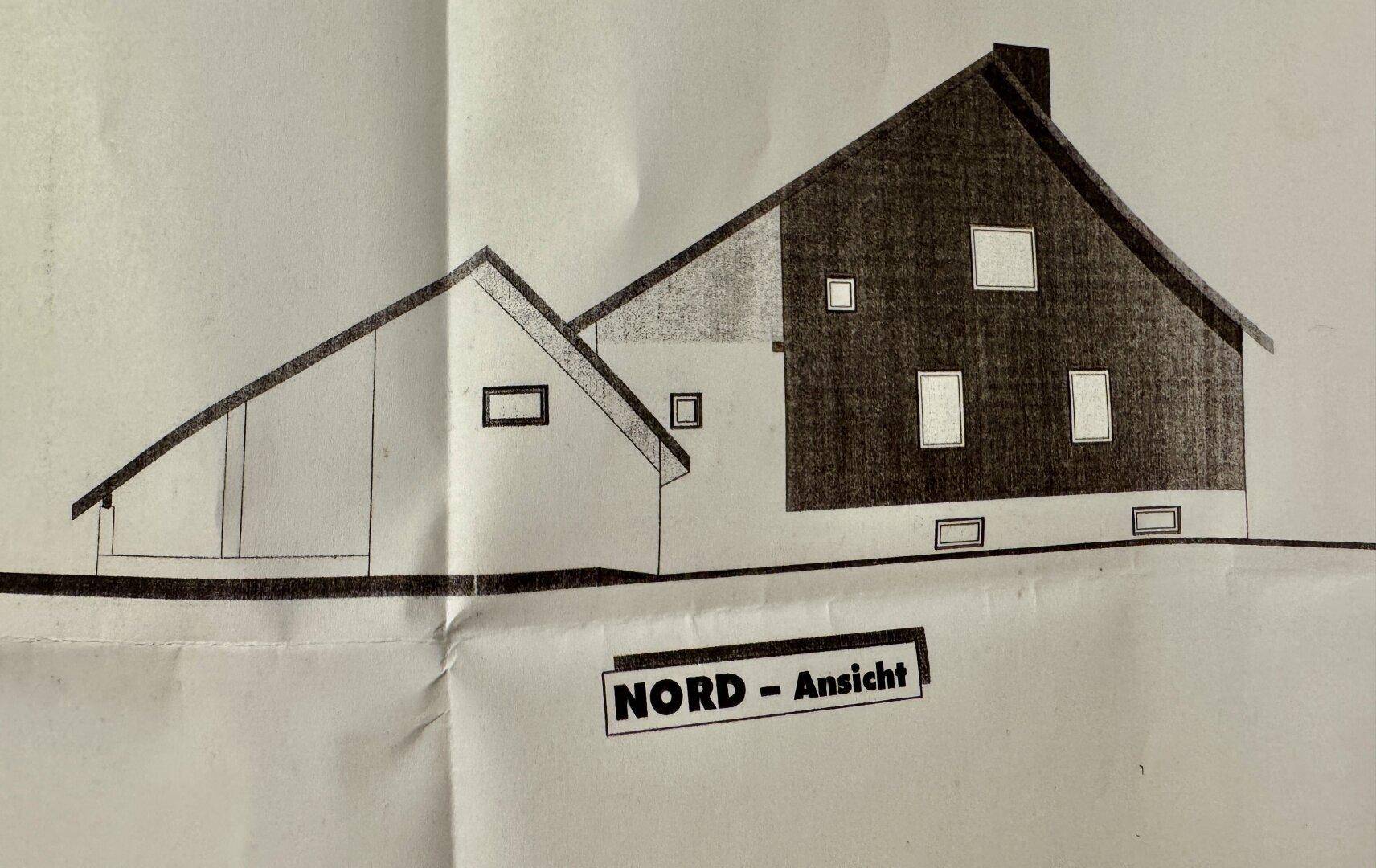 Nordansicht des Gebäudes mit verschiedenen Fenstergrößen und der markanten Dachkonstruktion.