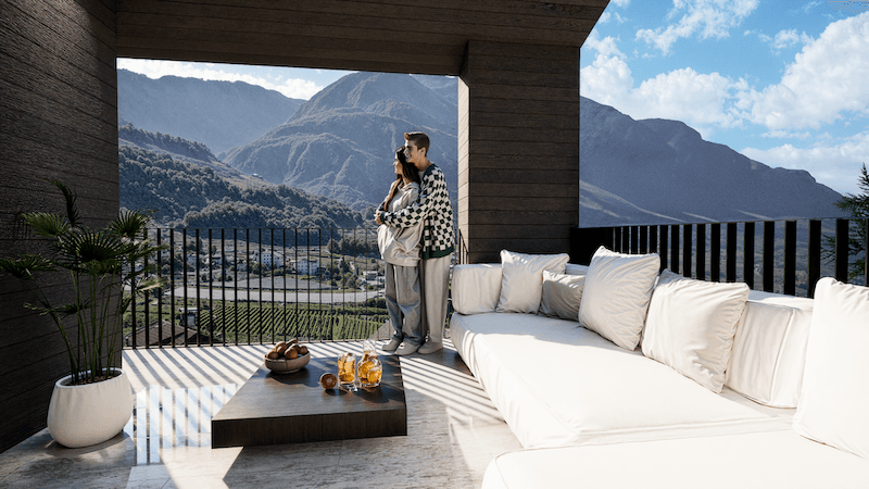Gemütliche Loggia mit Lounge-Sofa und atemberaubendem Blick auf die Bergwelt und das Tal.