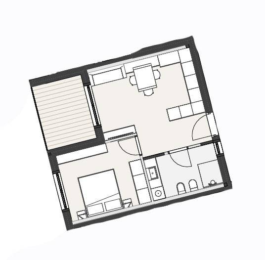 Grundriss einer Wohneinheit mit Schlafzimmer, Bad, offenem Wohnbereich und Balkon.