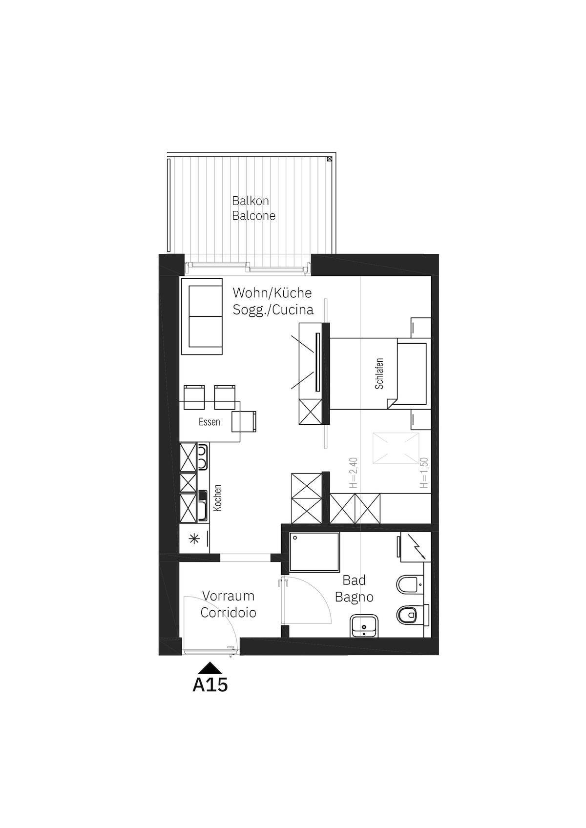 Grundriss einer Wohnung mit offenem Wohn-/Küchenbereich, Schlafzimmer und Balkon.