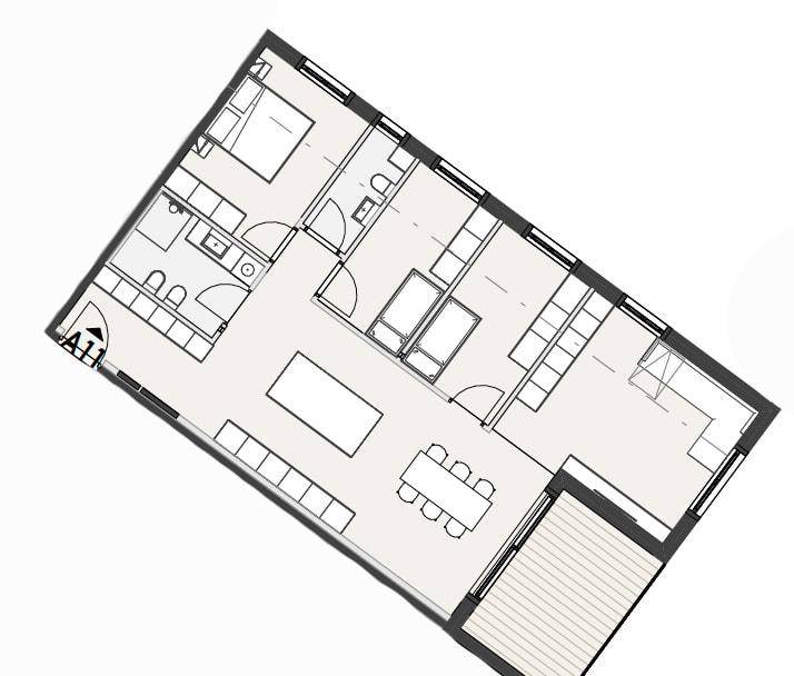 Grundriss einer Wohnung mit offenem Wohnbereich, Schlafzimmer und großem Balkon.