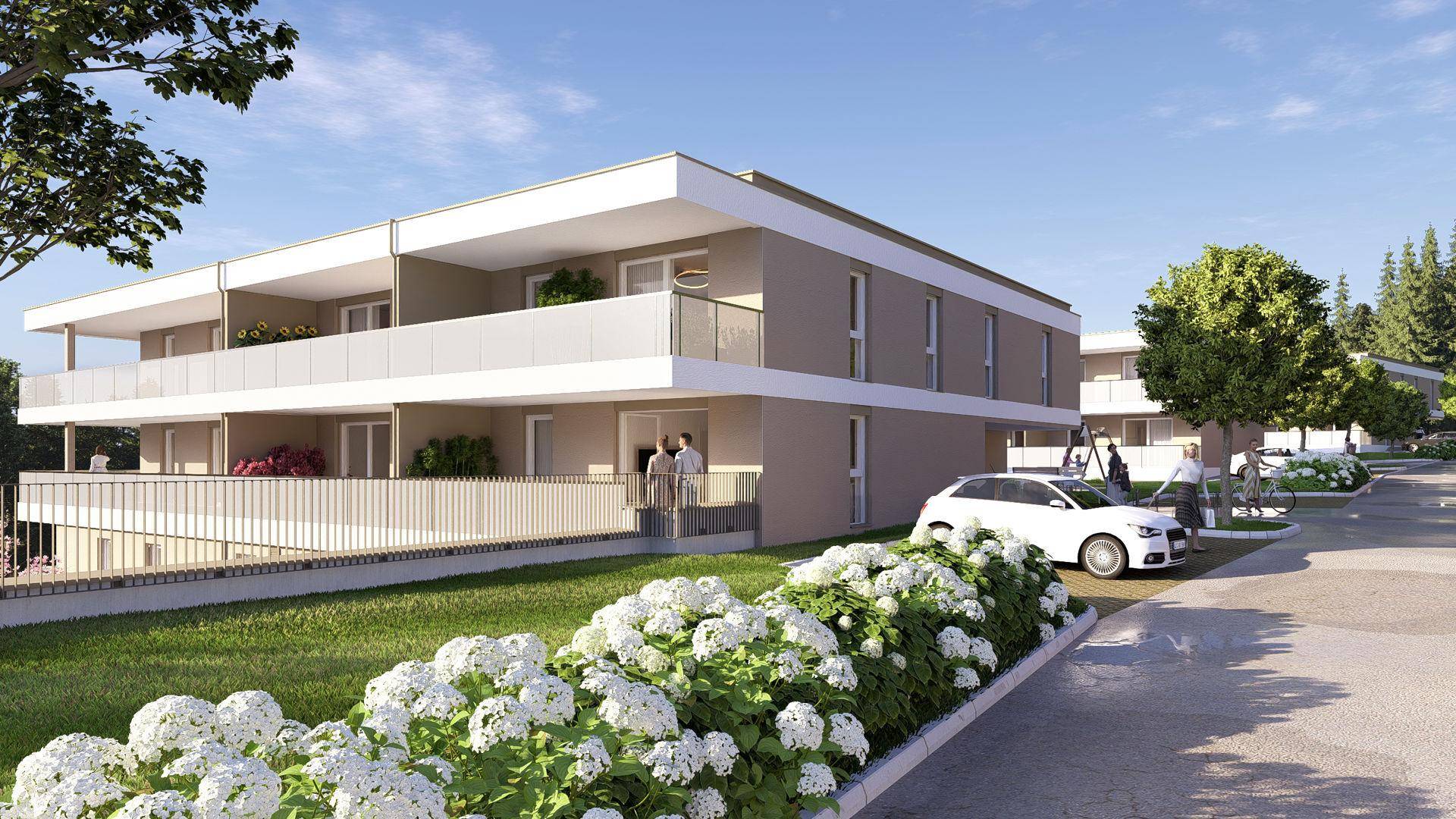 Moderne Wohnanlage mit gepflegter Außenansicht, Parkplätzen und Blumenbeeten.