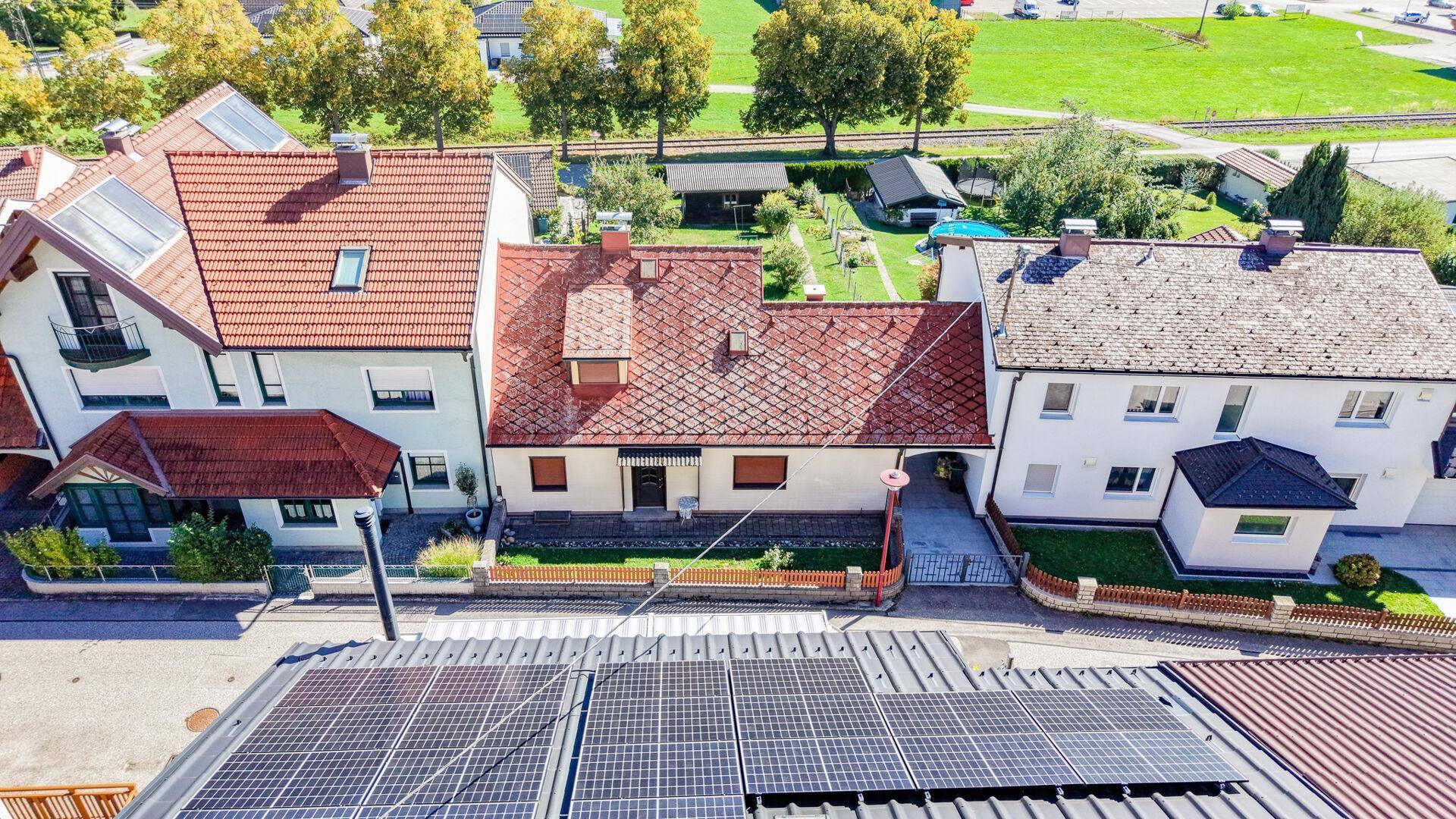 Dachansicht des Hauses mit Solaranlage und Blick auf die Nachbarschaft und Landschaft.
