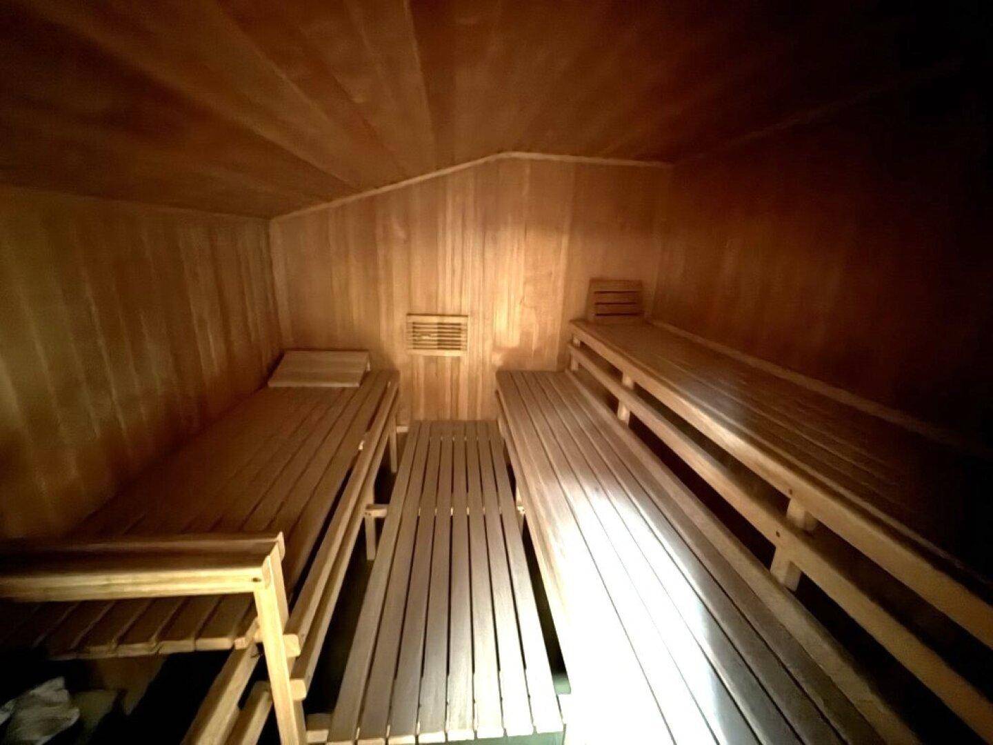 Gemütliche Holzsauna mit mehreren Bänken, ideal zur Entspannung und Erholung.