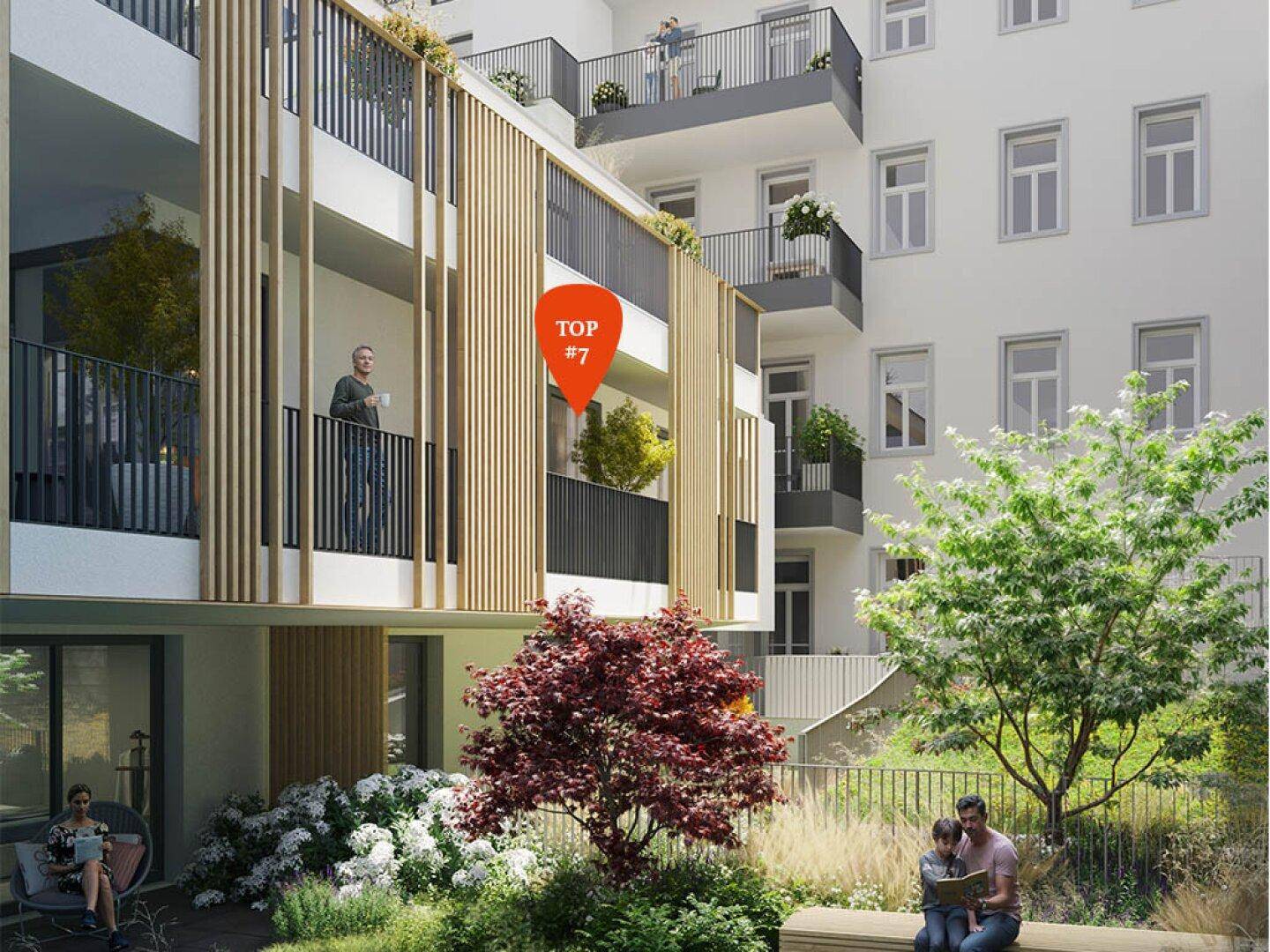 Moderne Wohnanlage mit attraktiven Balkonen und einem begrünten Innenhof mit Sitzgelegenheiten.
