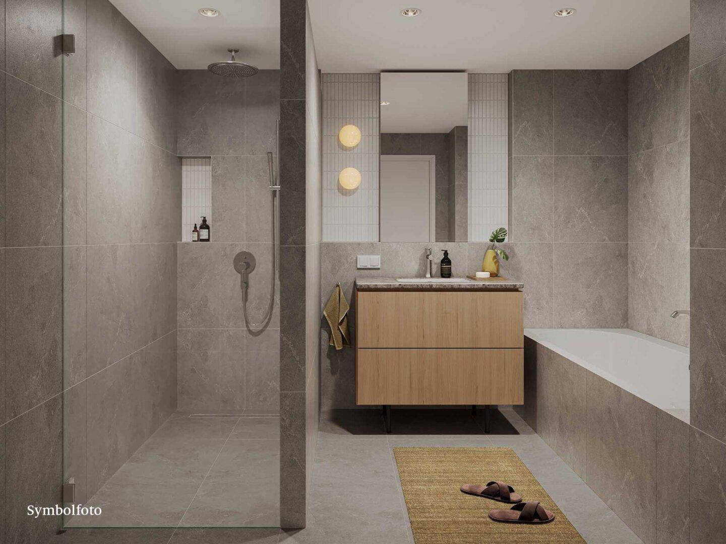 Modernes Badezimmer mit grauen Fliesen, begehbarer Dusche, Einzelwaschbecken und Badewanne.