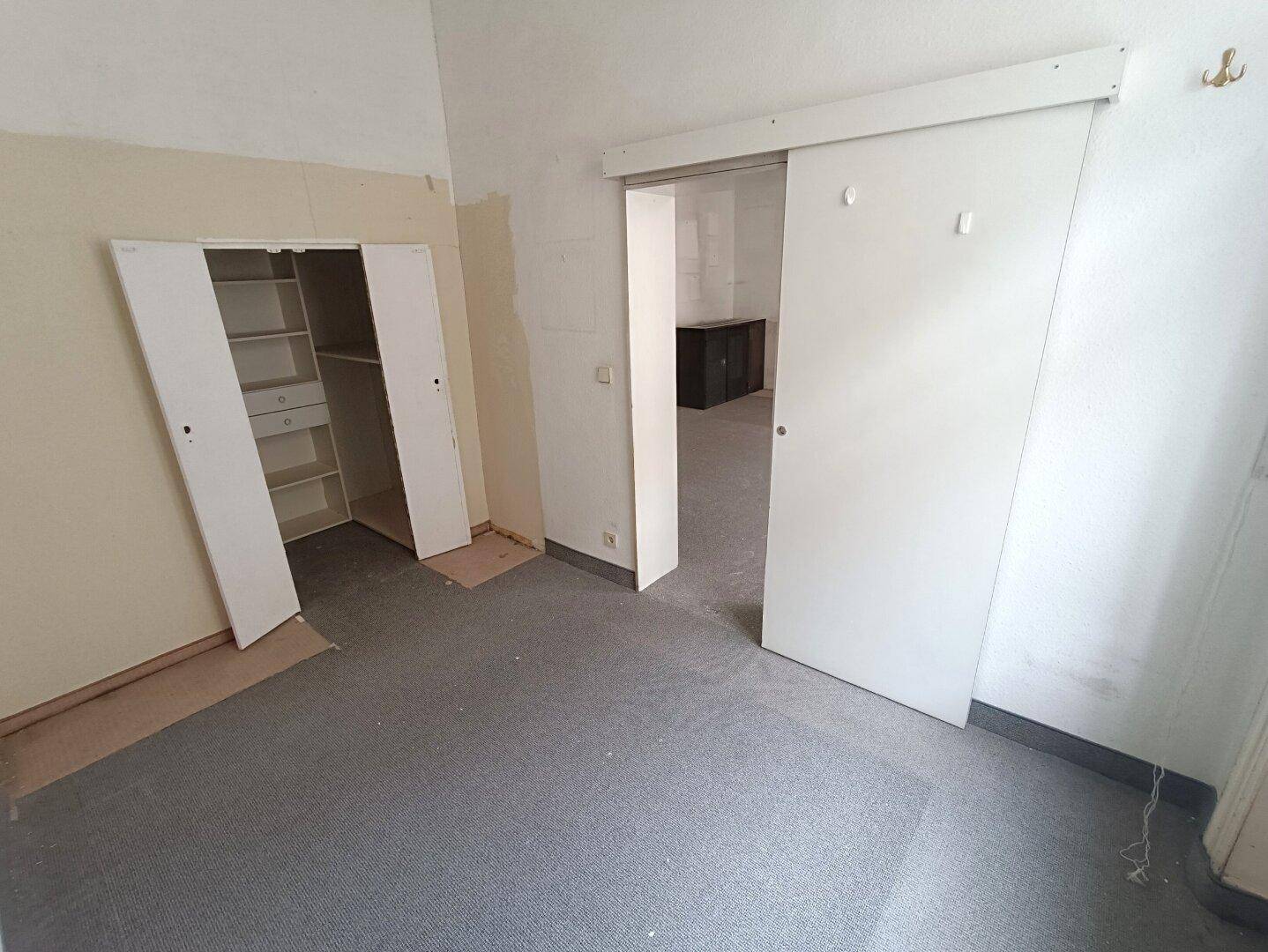 Innenraum mit eingebautem Kleiderschrank und Schiebetür, ideal für ein Schlafzimmer oder Ankleidezimmer.