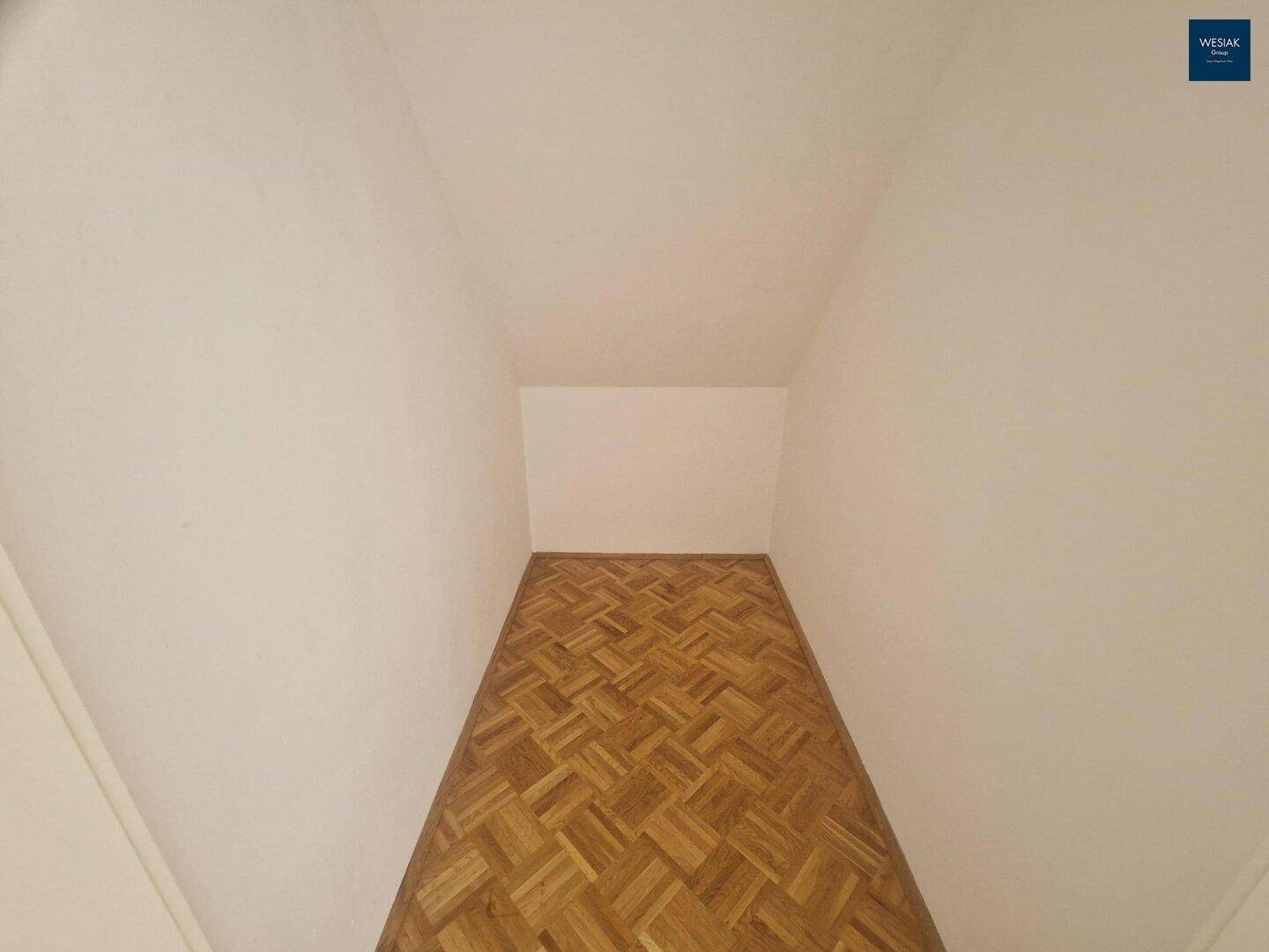 Kleiner Raum im Dachgeschoss mit Parkettboden, ideal als Abstellraum oder begehbarer Kleiderschrank.