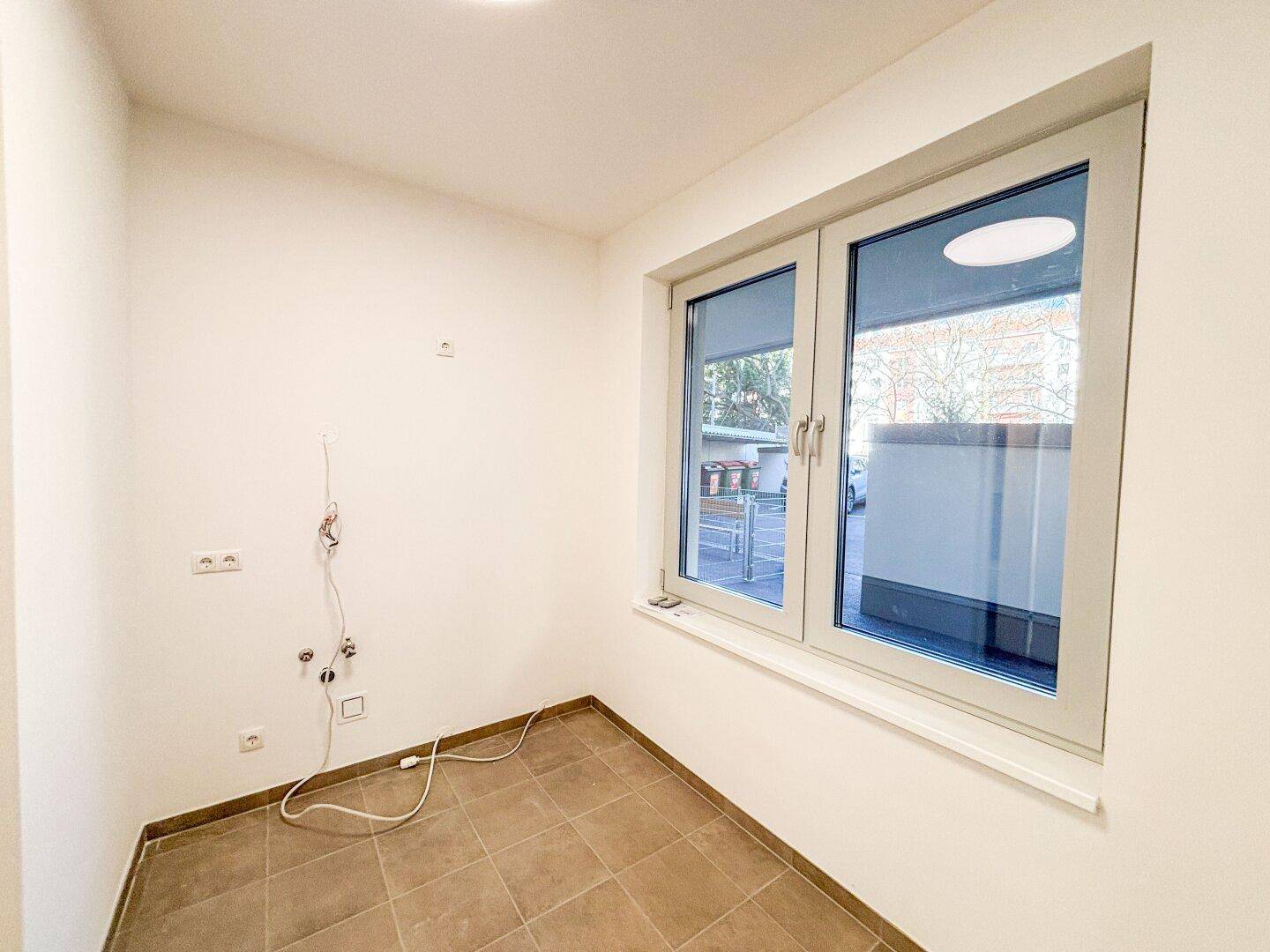 Kleiner, heller Raum mit Fenster und Fliesenboden, ideal als Abstellraum oder kleines Büro, bereit zur Nutzung.