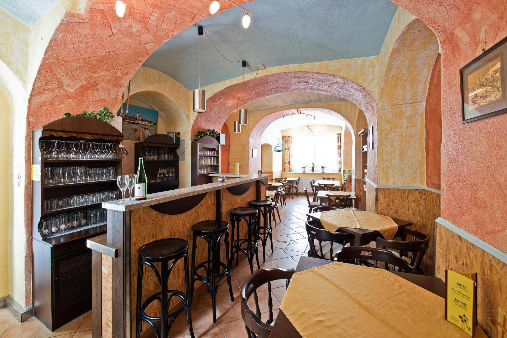 Rustikale Bar mit Gewölbedecken, Holzelementen und gemütlichen Sitzgelegenheiten, ideal für gesellige Abende.