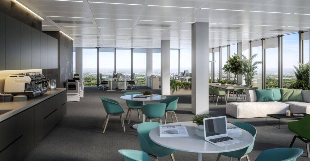 Moderner Büroloungebereich mit Teeküche, bequemen Sitzgelegenheiten und weitem Ausblick durch große Fenster.